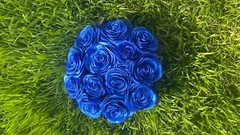 bouquet of blue roses from satin ribbons in a round black box