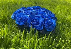 bouquet of blue roses from satin ribbons in a round black box