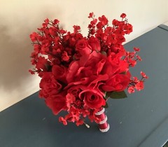 Red roses, rosebuds and red baby’s breath bridal bouquet