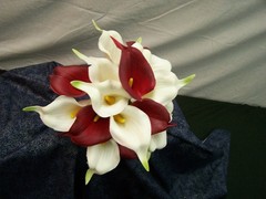 Red and white calla lily floral bouquet with matching boutonnierre