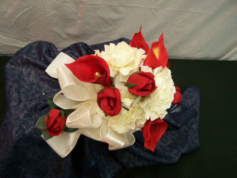 Red roses, red calla lilies and white carnation floral bouquet