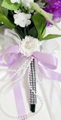 Wedding bouquet. Artificial flowers accessory with pearls and ribbons