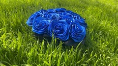 bouquet of blue roses from satin ribbons in a round black box