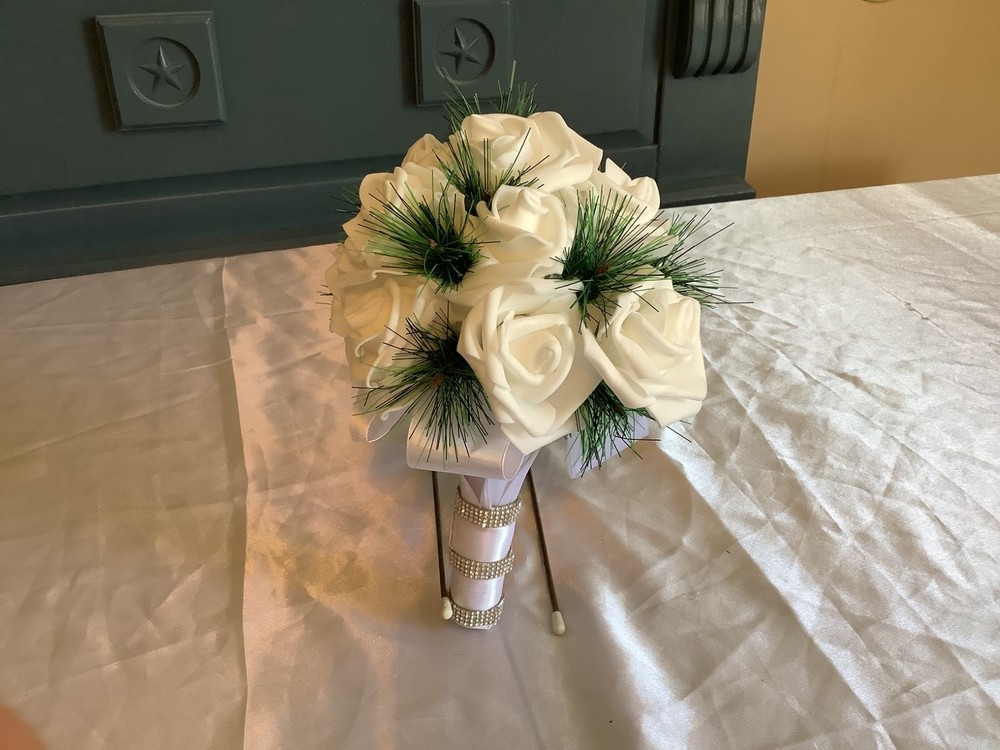 Winter pine and real touch rose bouquet