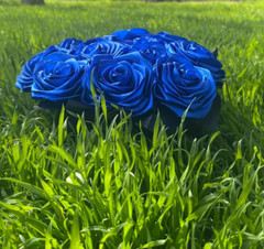 bouquet of blue roses from satin ribbons in a round black box